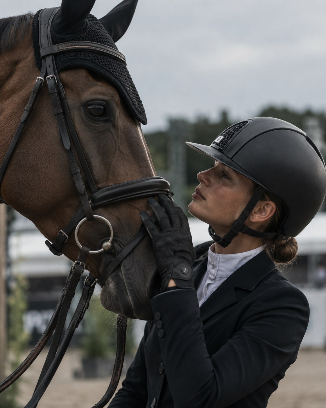 Equestrian athlete sharing a quiet moment with her horse